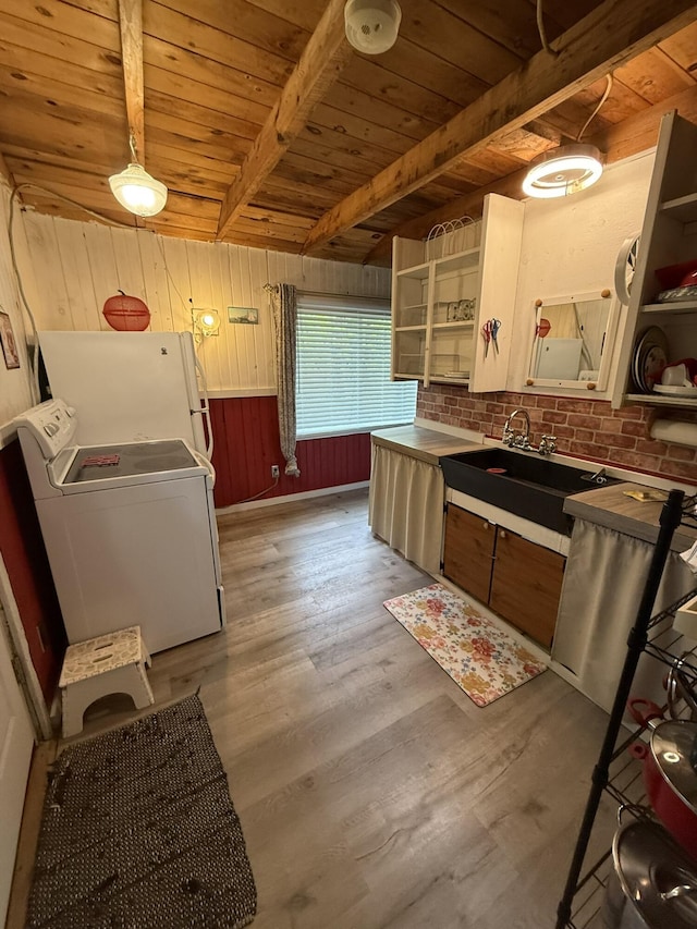 26-28 Acorn Rd, Naples, ME 04055 - kitchen with washer / clothes dryer, open shelves, a sink, wooden ceiling with exposed beams, and freestanding refrigerator