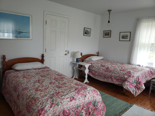 579 Cranberry Rd, Great Cranberry, Cranberry Isles, ME 04625 - bedroom featuring wood finished floors and multiple windows