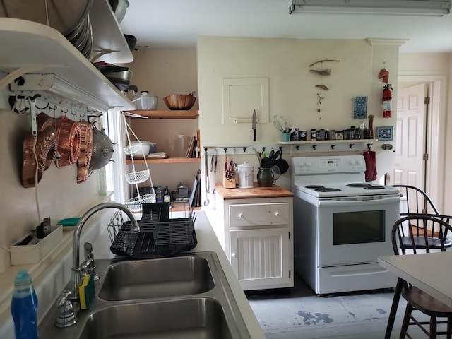 579 Cranberry Rd, Great Cranberry, Cranberry Isles, ME 04625 - kitchen with electric range, a sink, open shelves, and white cabinets