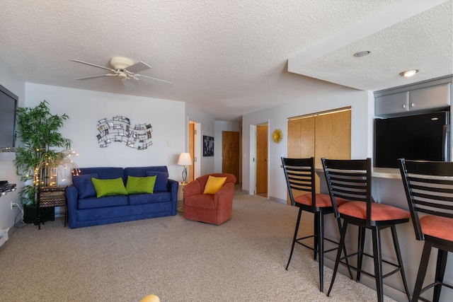 205 E Grand Ave Unit 7E, Old Orchard Beach, ME 04064 - living area featuring a ceiling fan, light colored carpet, and a textured ceiling
