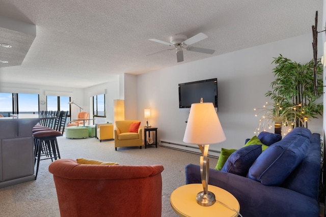 205 E Grand Ave Unit 7E, Old Orchard Beach, ME 04064 - carpeted living room featuring a textured ceiling, a ceiling fan, and a baseboard heating unit