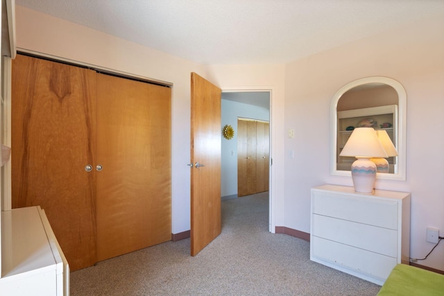 205 E Grand Ave Unit 7E, Old Orchard Beach, ME 04064 - bedroom featuring a closet, carpet floors, and baseboards