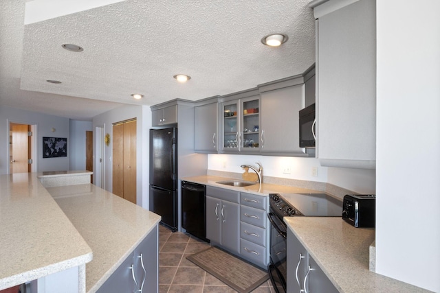 205 E Grand Ave Unit 7E, Old Orchard Beach, ME 04064 - kitchen with black appliances, a sink, gray cabinetry, glass insert cabinets, and a textured ceiling