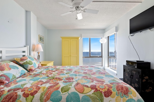 205 E Grand Ave Unit 7E, Old Orchard Beach, ME 04064 - bedroom featuring a water view, a textured ceiling, access to exterior, and ceiling fan