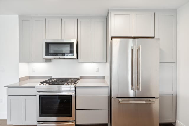 218 Washington Ave Unit 309, Portland, ME 04101 - kitchen with stainless steel appliances, light countertops, and baseboards
