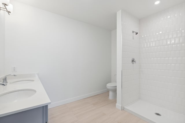 218 Washington Ave Unit 309, Portland, ME 04101 - full bathroom with tiled shower, wood finished floors, toilet, recessed lighting, and baseboards