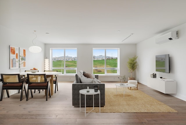218 Washington Ave Unit 309, Portland, ME 04101 - living room featuring light wood-style flooring, a wall unit AC, and baseboards