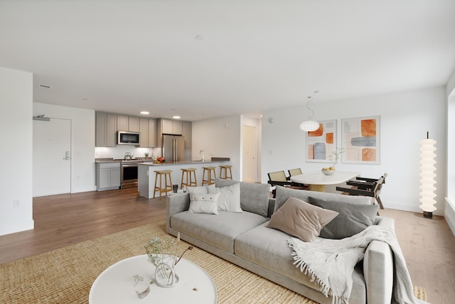 218 Washington Ave Unit 309, Portland, ME 04101 - living room featuring wood finished floors, recessed lighting, and baseboards