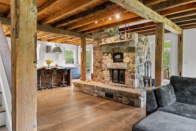 6 Bluebird Way, Kennebunk, ME 04043 - living area featuring hardwood / wood-style flooring, a fireplace, and wood ceiling with exposed beams