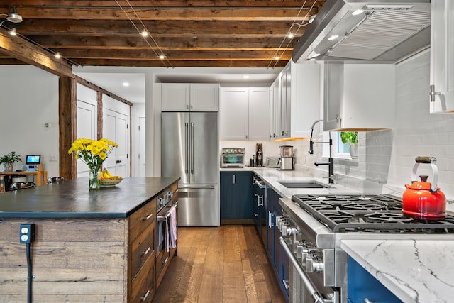 6 Bluebird Way, Kennebunk, ME 04043 - kitchen featuring high quality appliances, wall chimney range hood, dark wood-style flooring, a sink, and white cabinets