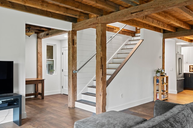 6 Bluebird Way, Kennebunk, ME 04043 - living room featuring stairway, wood finished floors, baseboards, and beamed ceiling