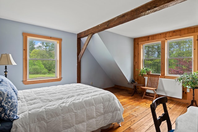 6 Bluebird Way, Kennebunk, ME 04043 - bedroom with radiator heating unit, multiple windows, light wood-style flooring, and beamed ceiling