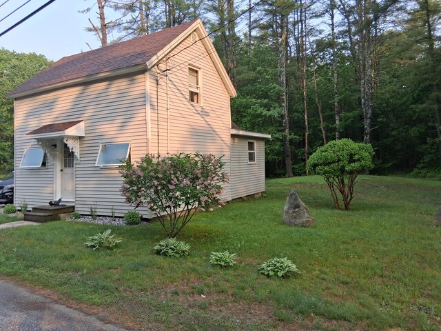 41 Winter St, Lisbon, ME 04250 - view of home's exterior featuring a lawn and roof with shingles