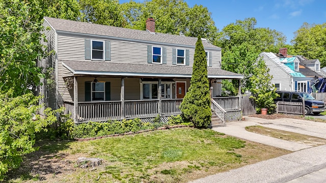 23 Paul St, South Berwick, ME 03908 - view of front of home featuring a porch, a front lawn, a chimney, and roof with shingles