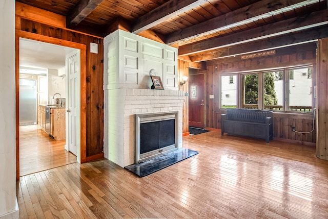 23 Paul St, South Berwick, ME 03908 - living room with wooden ceiling with exposed beams, wood walls, hardwood / wood-style flooring, and a fireplace