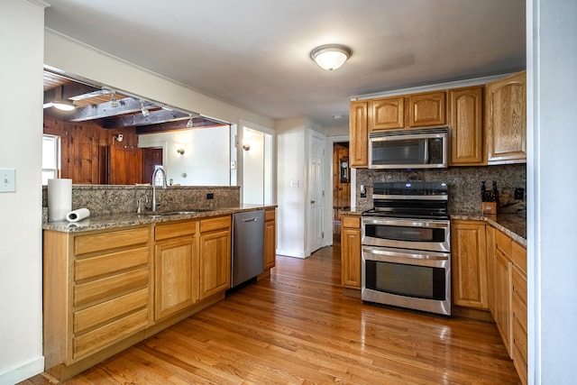 23 Paul St, South Berwick, ME 03908 - kitchen with appliances with stainless steel finishes, a sink, decorative backsplash, and light wood-style flooring