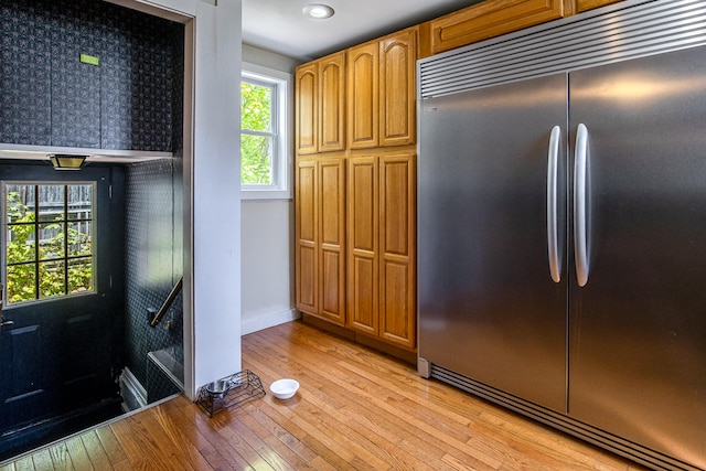 23 Paul St, South Berwick, ME 03908 - kitchen featuring stainless steel built in refrigerator, light wood finished floors, baseboards, recessed lighting, and brown cabinetry