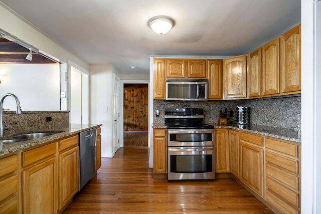 23 Paul St, South Berwick, ME 03908 - kitchen featuring appliances with stainless steel finishes, a sink, backsplash, dark stone countertops, and wood finished floors