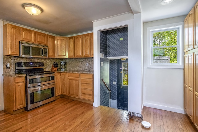23 Paul St, South Berwick, ME 03908 - kitchen with appliances with stainless steel finishes, baseboards, tasteful backsplash, light wood-style floors, and stone counters