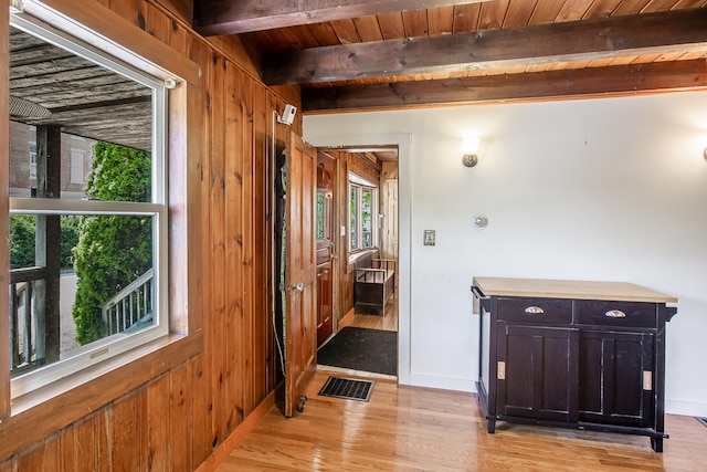23 Paul St, South Berwick, ME 03908 - hallway with light wood-style flooring, wooden ceiling with exposed beams, baseboards, and wood walls