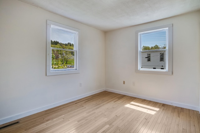 23 Paul St, South Berwick, ME 03908 - spare room with healthy amount of natural light, baseboards, and wood-type flooring
