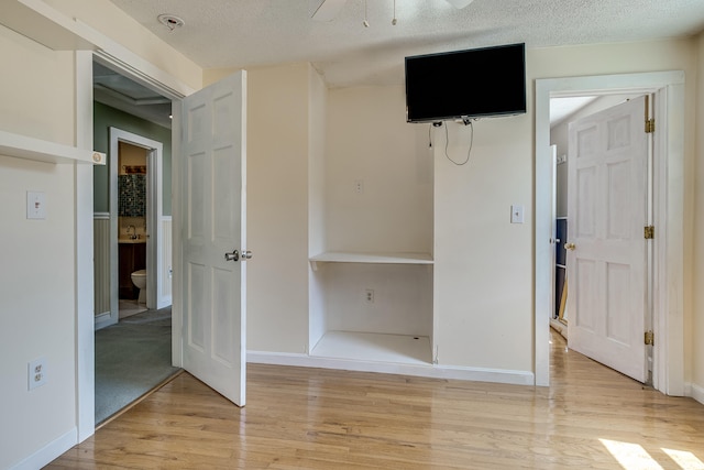23 Paul St, South Berwick, ME 03908 - unfurnished bedroom with light wood-style flooring, a textured ceiling, and baseboards