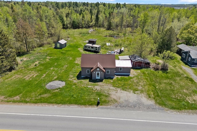 view from above of property with a heavily wooded area
