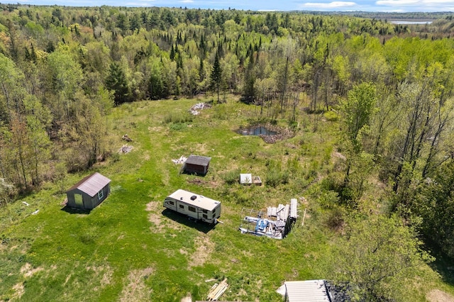 view of property location with a heavily wooded area