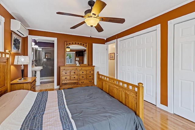 bedroom with a wall unit AC, light wood finished floors, baseboards, a ceiling fan, and ornamental molding
