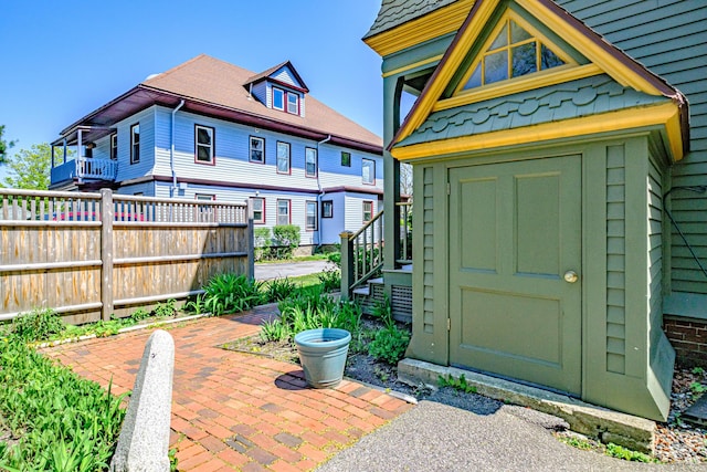 view of shed featuring fence
