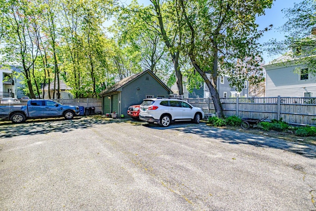 view of vehicle parking featuring fence