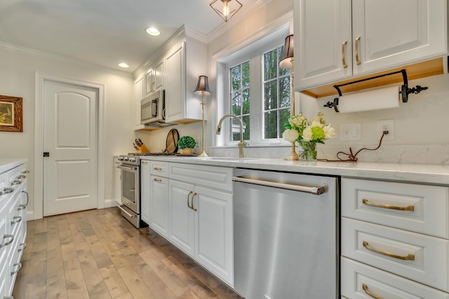 4 Brown Hill Ln, Scarborough, ME 04074 - kitchen with stainless steel appliances, ornamental molding, white cabinets, light wood-style flooring, and recessed lighting