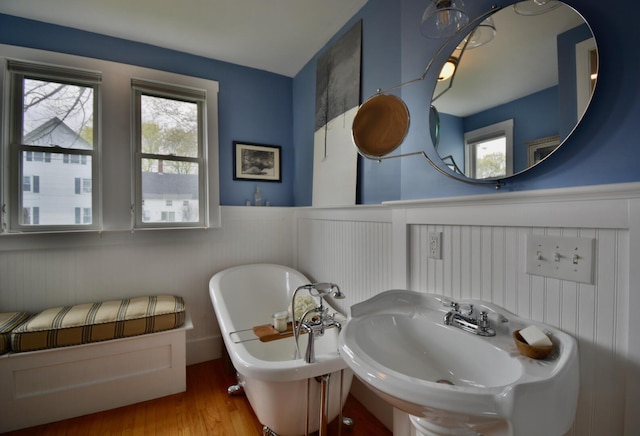 131 N St, Bath, ME 04530 - full bath with a sink, healthy amount of natural light, a freestanding bath, wainscoting, and a decorative wall