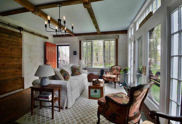 131 N St, Bath, ME 04530 - living area with wooden walls, beamed ceiling, a barn door, a chandelier, and hardwood / wood-style floors