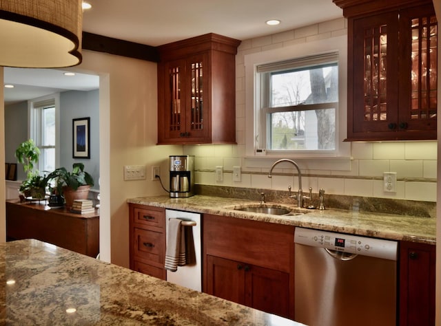 131 N St, Bath, ME 04530 - kitchen with stainless steel dishwasher, a sink, light stone counters, glass insert cabinets, and recessed lighting