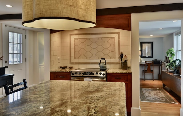 131 N St, Bath, ME 04530 - kitchen with electric range, decorative backsplash, light stone countertops, wood finished floors, and recessed lighting
