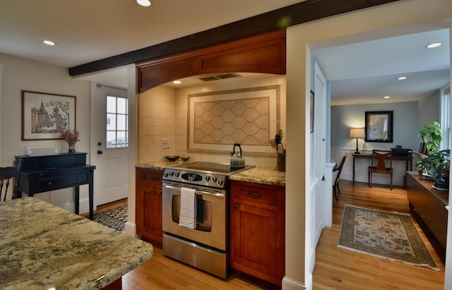 131 N St, Bath, ME 04530 - kitchen featuring stainless steel electric stove, decorative backsplash, light wood-type flooring, light stone counters, and recessed lighting