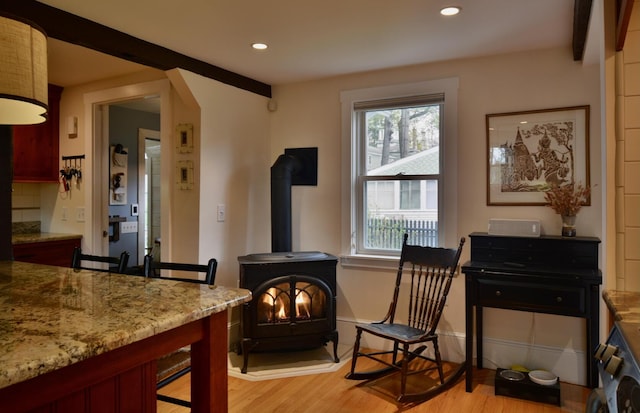 131 N St, Bath, ME 04530 - living area with a wood stove, light wood-style flooring, recessed lighting, baseboards, and arched walkways
