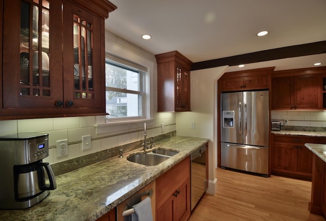 131 N St, Bath, ME 04530 - kitchen with stainless steel refrigerator with ice dispenser, a sink, dishwashing machine, tasteful backsplash, and light wood-style flooring
