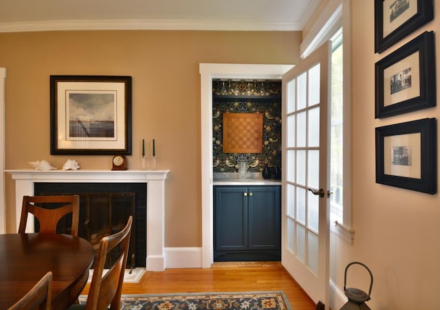 131 N St, Bath, ME 04530 - dining area featuring light wood finished floors, ornamental molding, a fireplace, and french doors