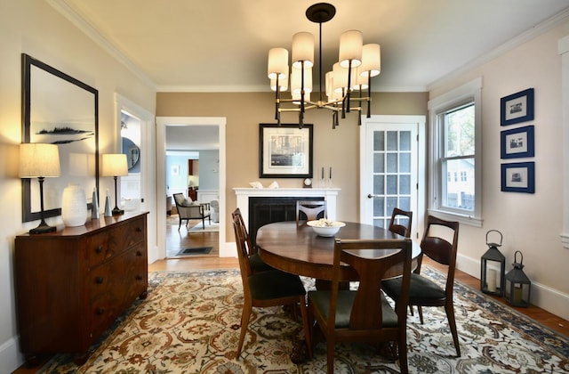 131 N St, Bath, ME 04530 - dining area with wood finished floors, ornamental molding, a chandelier, and baseboards