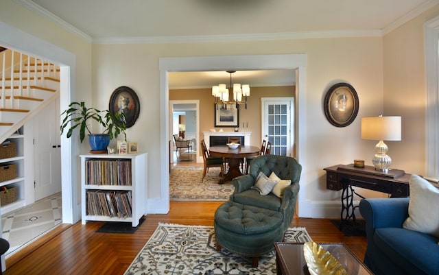 131 N St, Bath, ME 04530 - living room with stairs, a chandelier, ornamental molding, baseboards, and wood finished floors