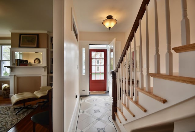 131 N St, Bath, ME 04530 - tiled foyer entrance with inlaid floor details, healthy amount of natural light, stairs, and baseboards