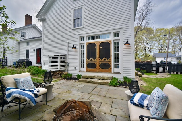 131 N St, Bath, ME 04530 - back of property featuring an outdoor fire pit, a patio, fence, and entry steps