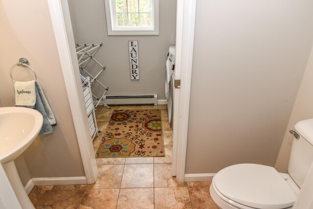 428 E Main St, Yarmouth, ME 04096 - bathroom with a baseboard heating unit, toilet, washer and dryer, baseboards, and tile patterned flooring