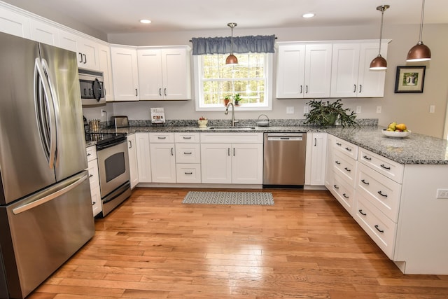428 E Main St, Yarmouth, ME 04096 - kitchen featuring stainless steel appliances, a sink, a peninsula, recessed lighting, and white cabinets