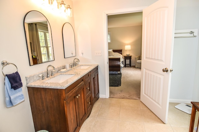428 E Main St, Yarmouth, ME 04096 - ensuite bathroom with double vanity, baseboards, and tile patterned flooring