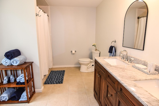 428 E Main St, Yarmouth, ME 04096 - full bathroom featuring tile patterned flooring, baseboards, toilet, and double vanity