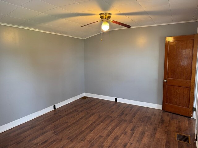 1575 Main St, Mapleton, ME 04757 - unfurnished room featuring ceiling fan, crown molding, dark wood-style floors, and baseboards