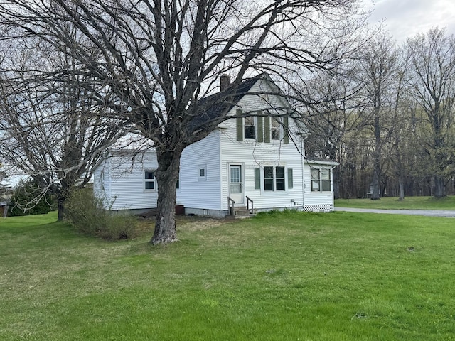 1575 Main St, Mapleton, ME 04757 - view of front of home featuring entry steps, a chimney, and a front lawn